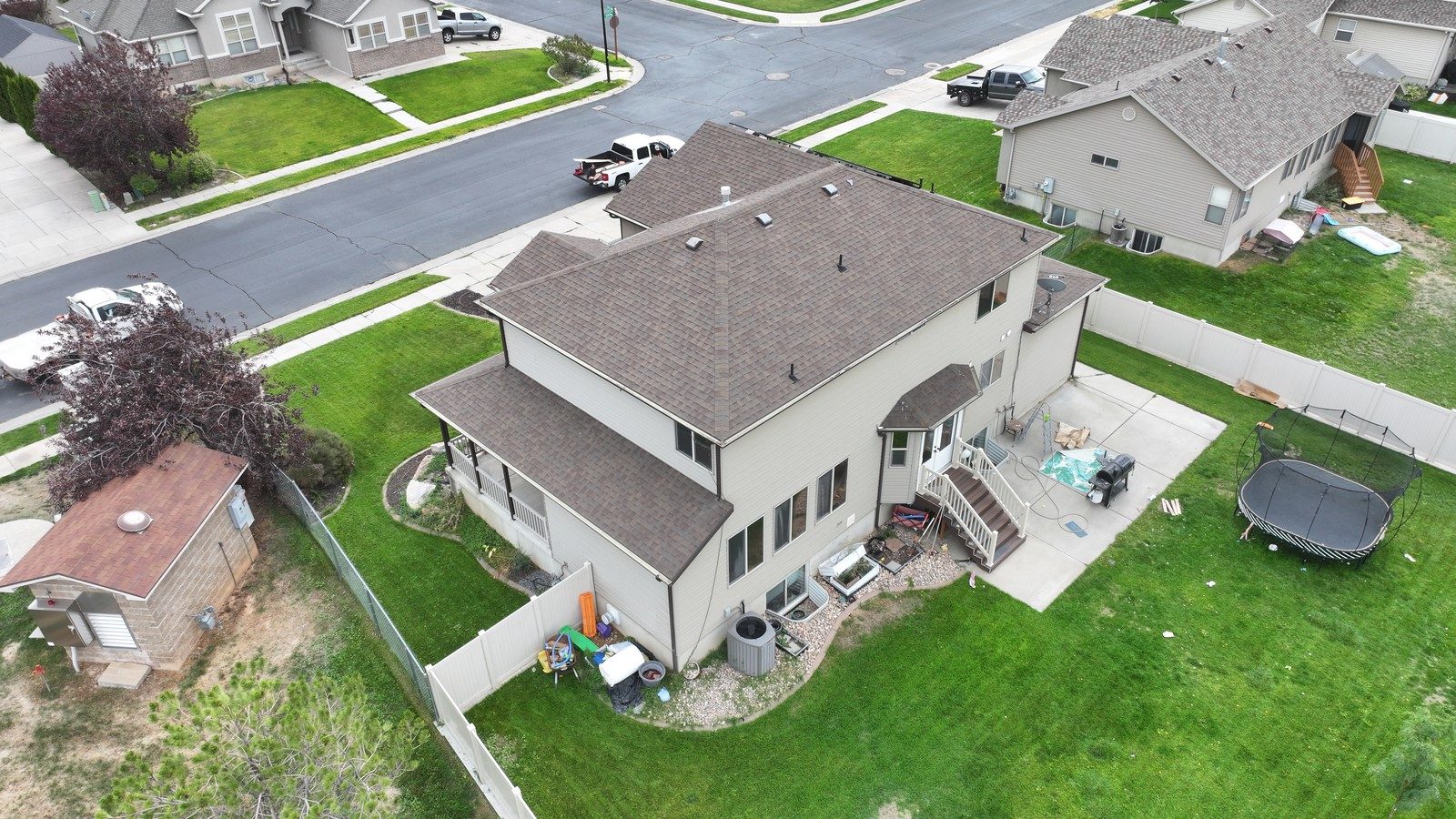 Drone view of a Utah home with brown asphalt shingles after inspection context