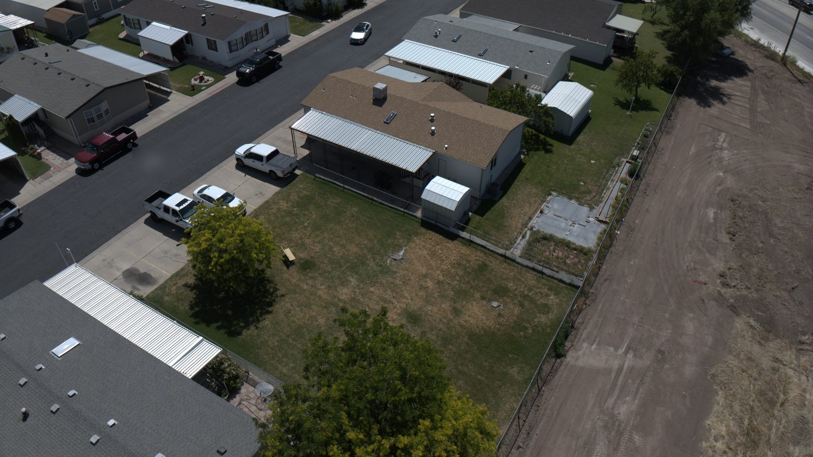 Aerial view of Utah homes with asphalt shingle roofs along a residential street