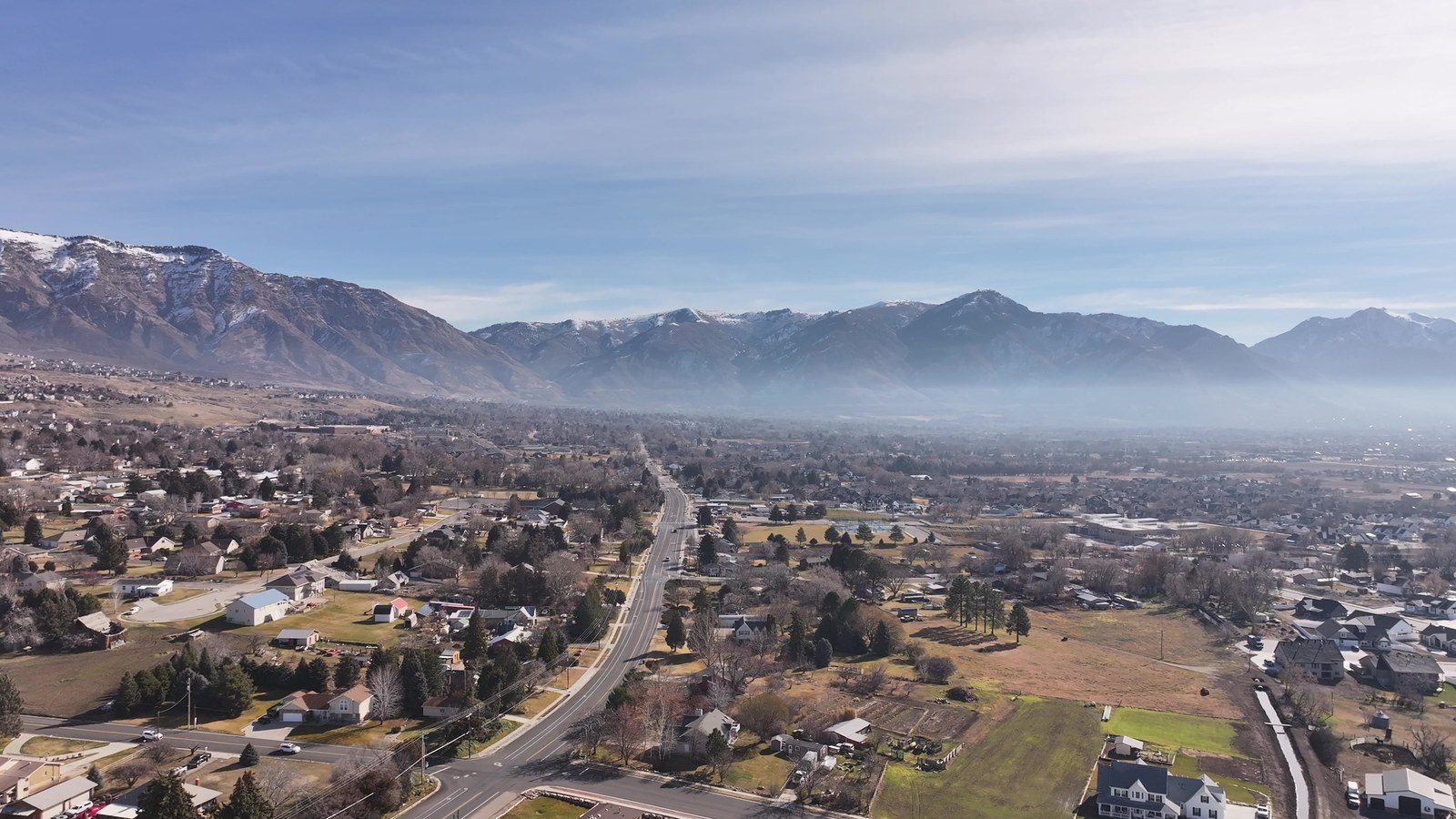 Aerial view of a northern Utah neighborhood below the Wasatch Mountains
