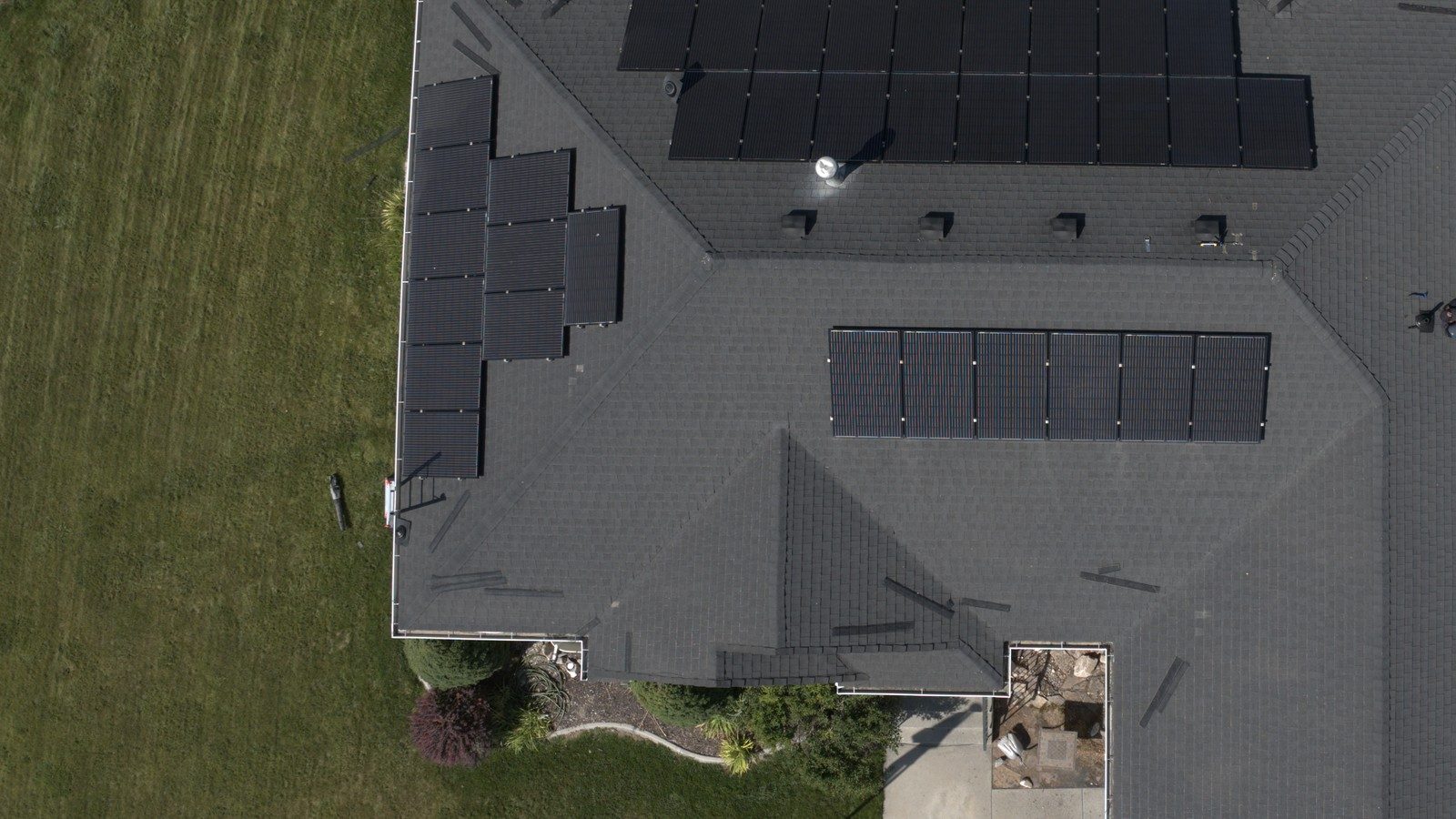 Top-down drone view of a Utah asphalt shingle roof with solar panels after inspection marking
