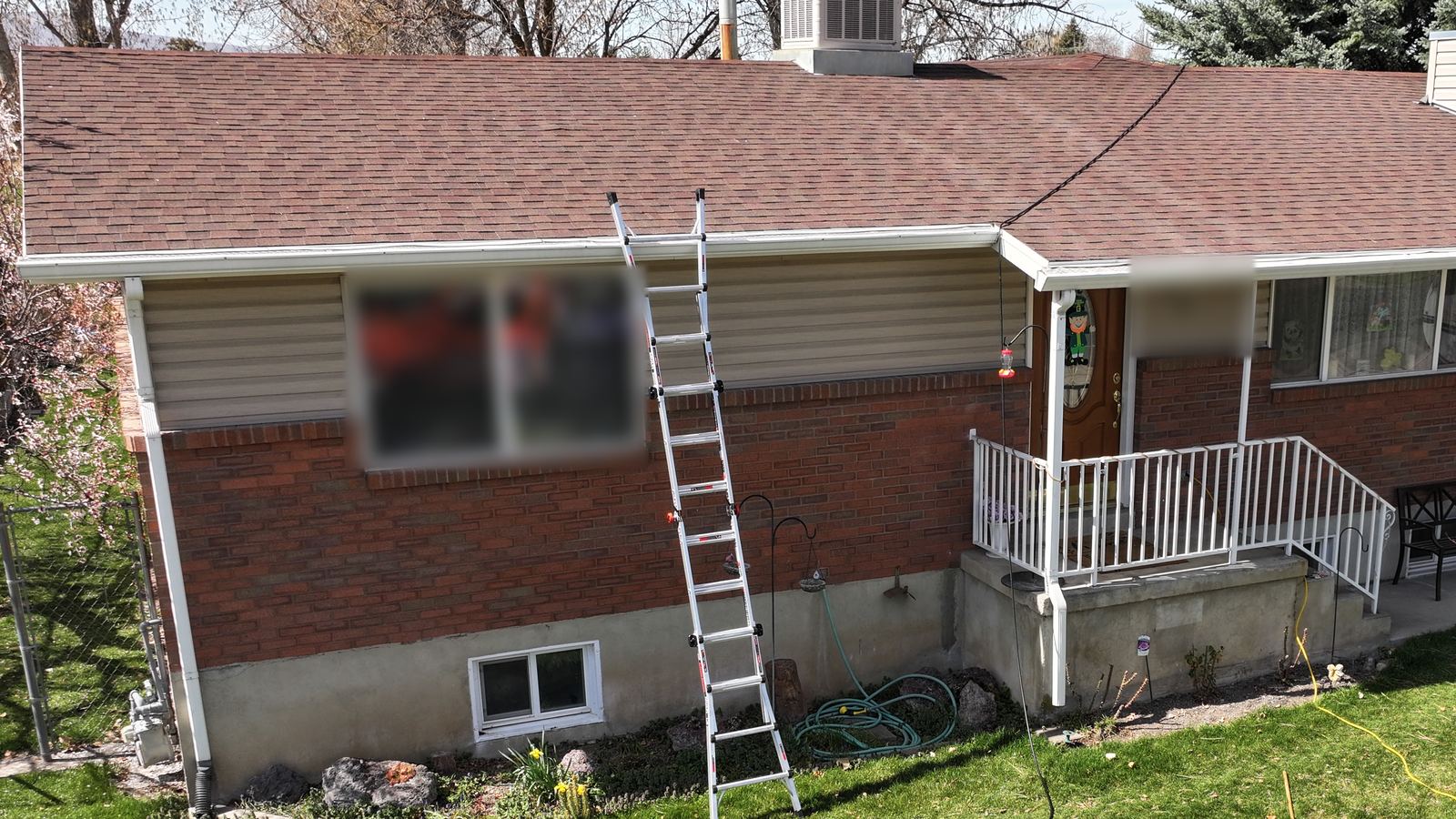 Front eaves, gutters and downspouts on a Northern Utah home with an asphalt shingle roof