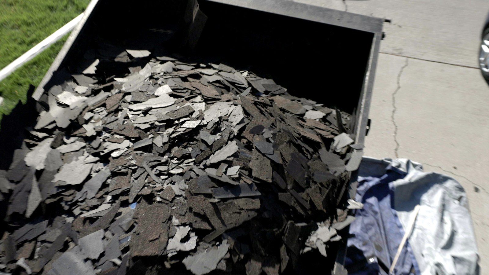 Trailer filled with torn-off asphalt shingles after a Utah roof tear-off