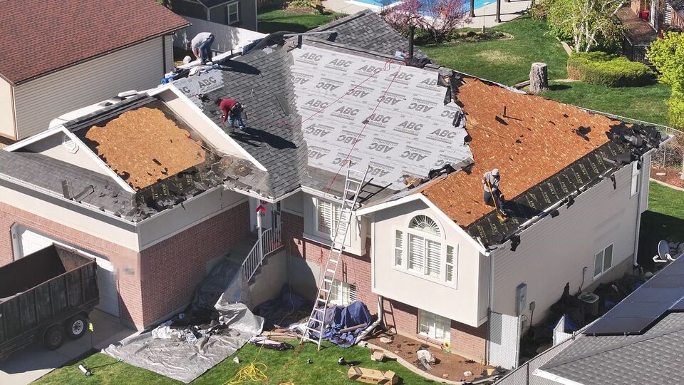 Asphalt shingle replacement in Utah, with new underlayment and shingles going on.