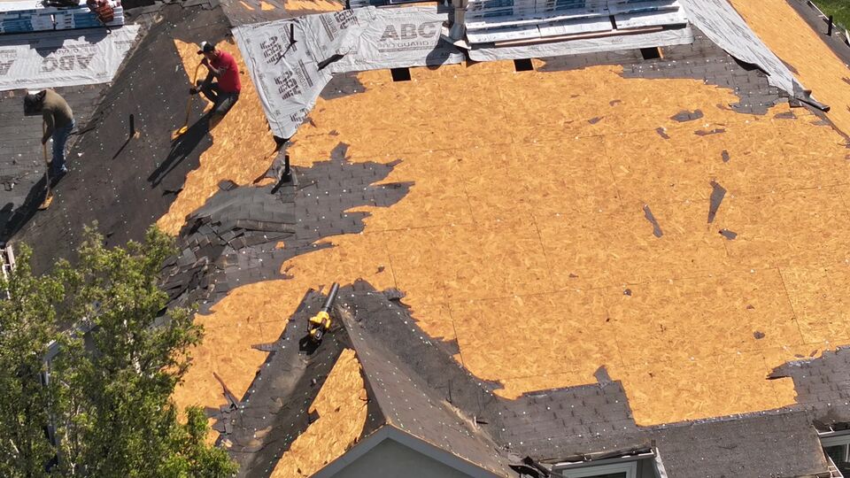 Open roof deck during asphalt shingle tear-off and replacement in Utah.